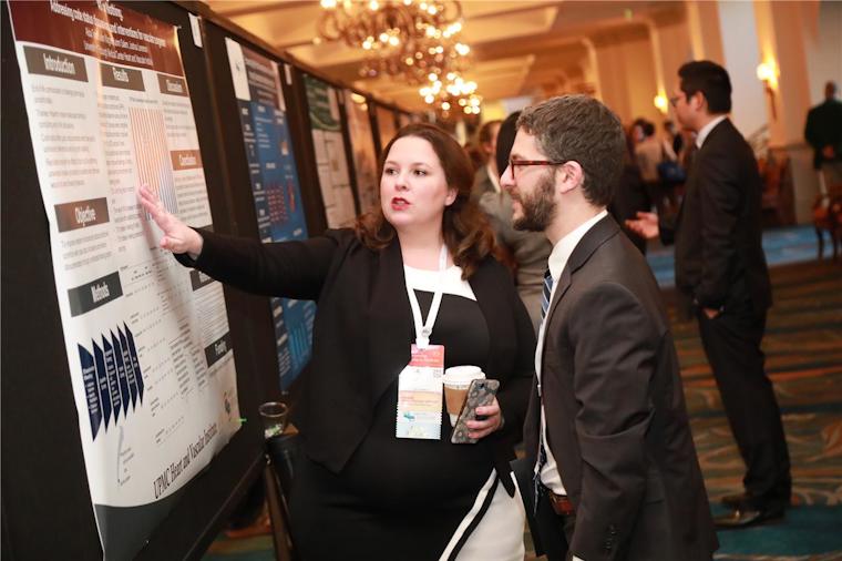A poster presenter discusses her work with an attendee. Ninety posters were featured at this year&#39;s conference.